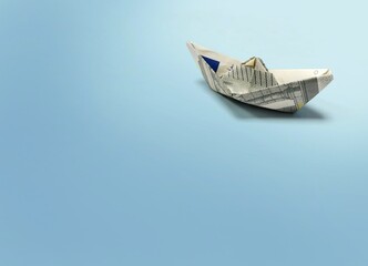 Origami ship of 5 euro banknote on blue background