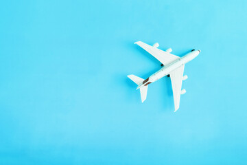 Naklejka na ściany i meble Travel flat lay composition airplane on yellow background with copy space