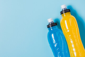 Isotonic energy drink copy space background.Sport beverage bottles blue and yellow liquid. - 507231417