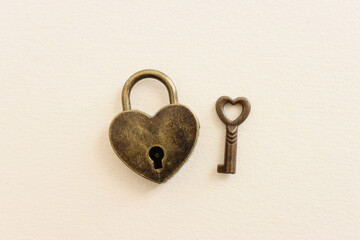 Heart shapes heart and vintage key over textured pastel background
