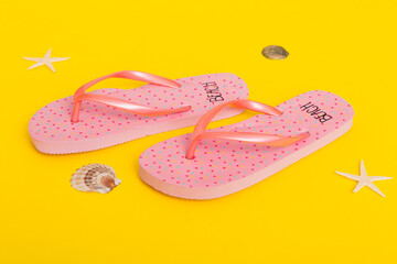 Beach accessories. Flip flops and starfish on colored background. Top view Mock up with copy space