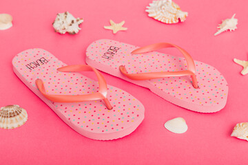 Beach accessories. Flip flops and starfish on colored background. Top view Mock up with copy space