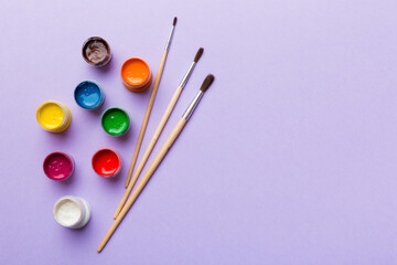 art palette with paint and brushes, close up. Top view with empty space. workplace for creativity. home teaching concept drawing