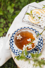 English tea in spring blossom garden. Vertical