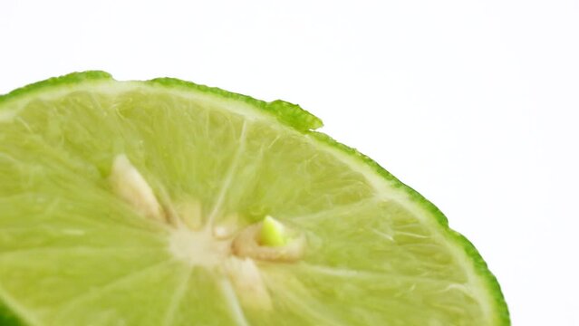4K Rotation of a green lime. Top view, 360 degree rotation, close-up of a lemon in a cut.