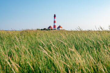 Fototapeta na wymiar Westerheversand Lighthouse and Salzwiesen (salt marsh), Westerhever, Nordfriesland, Schleswig-Holstein, Germany