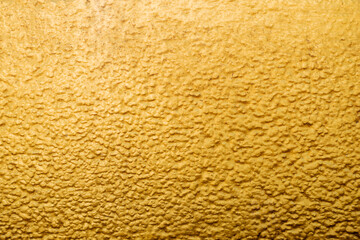Gold abstract concrete wall background or texture.