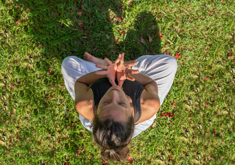 Top View of Young Woman Practicing Meditation Doing Mudra Gesture with Hands