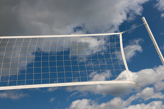 volleyball net on blue sky background with white clouds