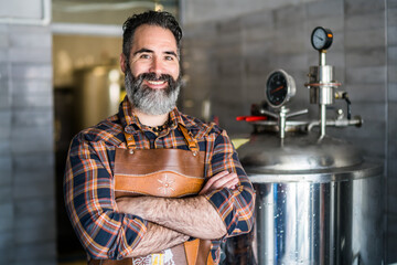Portrait of man who is working at craft beer factory. Small family business, production of craft...