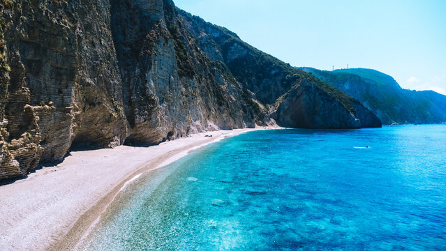 Paradise beach, chomi, Corfu in Greece. Drone shot of a turquoise coloured sea. Cliff and tropical beach.