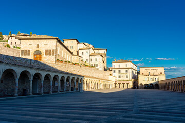 Fototapeta na wymiar ASSISI, ITALY, 6 AUGUST 2021 Historical buildings next to the church