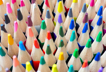 Close-up of coloured pencil tips standing upright. Art supplies. Focus towards the back.