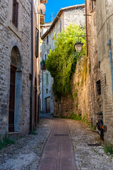 Fototapeta na wymiar Medieval street in the historic center of Spoleto, town in Umbria Italy