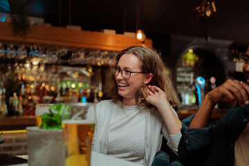 diverse work friends out for dinner laughing 