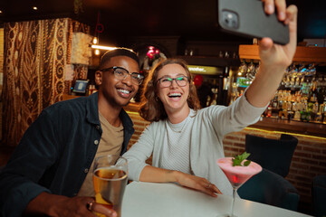diverse colleagues out for drinks taking selfies 