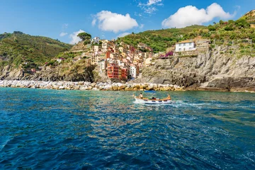 Fototapeten Cityscape of Riomaggiore village view from the sea, Cinque Terre National Park in Liguria, coast and seascape, La Spezia, Italy, Europe. UNESCO world heritage site. © Alberto Masnovo