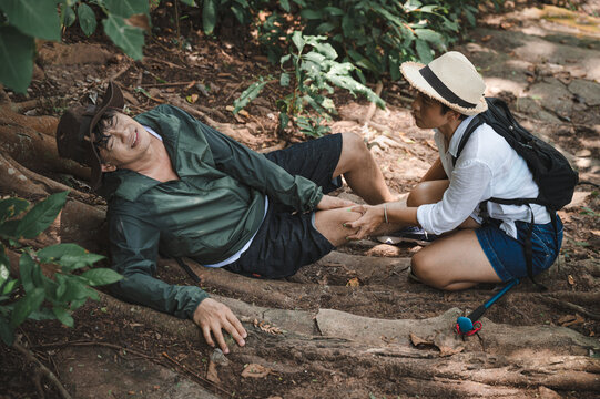 Trekking adult man with injured kneel pain in the wood	