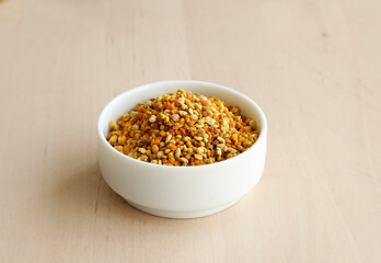 Bee pollen propolis. brown, blue, orange and yellow flower pollen grains or bee food. İsolated on wooden background