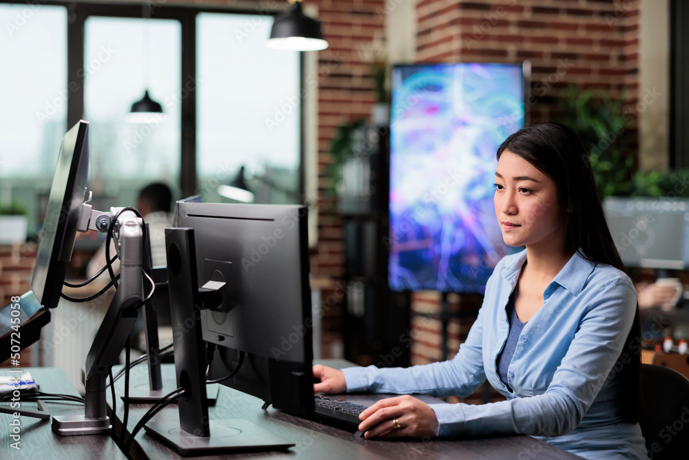 Poster creative agency employee working on developing digital project while sitting at desk. company office