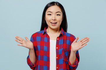 Young surprised amazed fun cool shocked woman of Asian ethnicity 20s in checkered shirt spread...