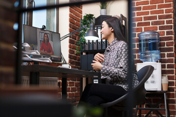 Startup project manager conversating online with investor about marketing strategy. Asian research analyst on online remote videocall conference with organization leader talking about management plan.