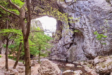 Imposing natural stone arches, Geomorphological natural monument. Vratna River Canyon, eastern Serbia. Amazing nature landscape. Spring day. 