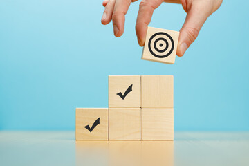 Business development strategy, advancement and goal concept. Hand putting wooden block pyramid with...