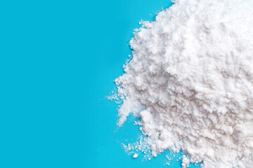 Baking soda on blue background.