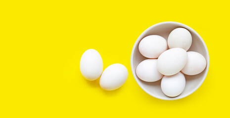 White eggs on yellow background.