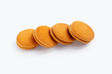 Custard cream sandwich biscuits on white background.