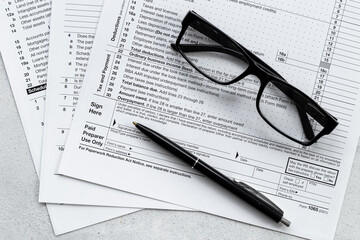 Businessman table with US tax form and pen. Culculating and payment of taxes
