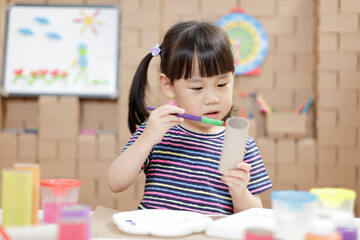 young girl making craft for homeschooling