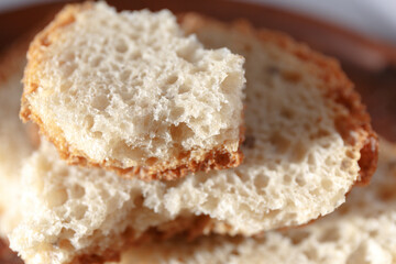 Homemade bread, pieces of broken bread, fresh pastries in the bakery.