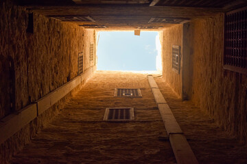 Fototapeta na wymiar Looking from the bottom of one of the basements of the Qaitbay Citadel in Alexandria, where the soldier stands above, and in the event of storming the castle, the soldiers throw fiery lava from the to