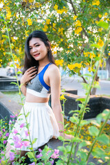 Portrait of beautiful athletic young asian woman in fashionable sportswear standing and having rest after strong exercise training in garden the park,Outdoor Sporty concept