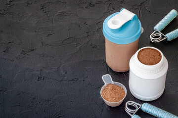 Sports food supplement. Whey protein powder in jar and shaker bottle