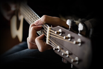 Acoustic Guitar Playing. Young men Playing Acoustic Guitar
