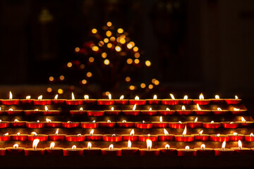 Candles are lit by believers at the moment of prayer for peace in the church. Memorial day with...