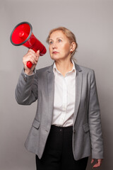 Business woman making announcement with megaphone or loudspeaker