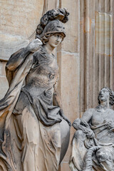 Old statue of beautiful woman with horn of plenty and Roman soldier in Potsdam University, Germany