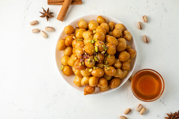 luqaimat arabic sweet dish, lokma on white background, top view.