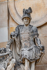 Old statue of beautiful woman with horn of plenty and Roman soldier in Potsdam University, Germany