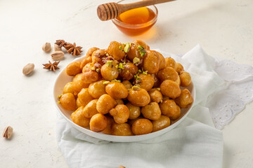 Sweetness from Qatar, Loukoumades, Fried balls of dough in syrup.