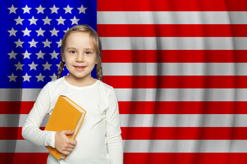 Happy little girl against USA flag background