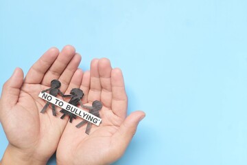 Anti-bullying and stop child bullying concept. Hand holding children with No To Bullying message....