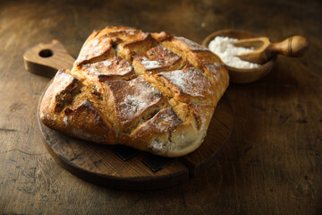Fresh artisan bread on a wooden desk