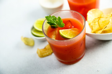 Homemade tomato cocktail with fresh lime