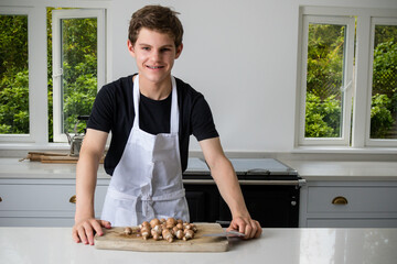 A Teenage Boy Cooking In A Kitchen