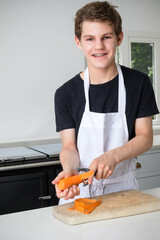 A Teenage Boy Cooking In A Kitchen